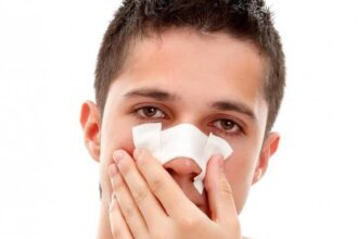 young man with sterile bandage over nose e1439808307690 نكش الأنف: الأسباب والمخاطر مجلة نقطة العلمية