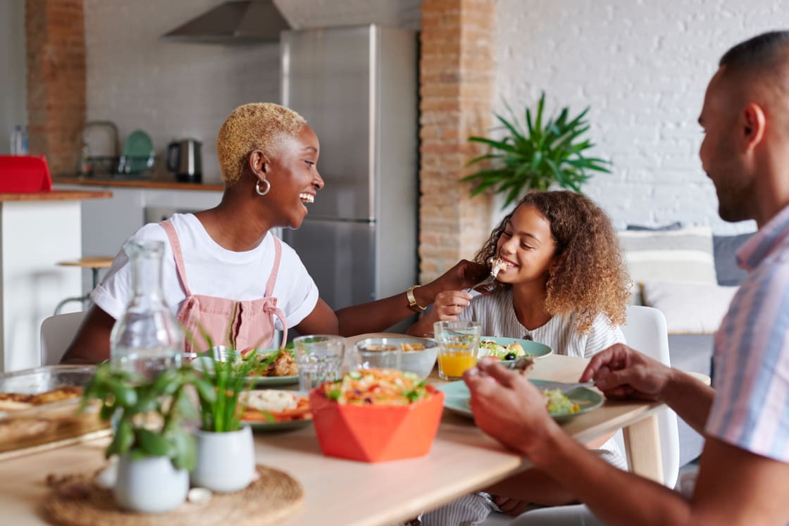 Family Eating Nutritious Meal Together At Dinner Table مجلة نقطة العلمية